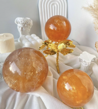 Load image into Gallery viewer, Moon Rituals - Radiant Honey Calcite Sphere | Natural Golden Yellow Calcite Crystal for Joy &amp; Confidence
